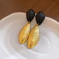 Close-up detail of geometric gold textured earrings featuring black wooden diamond studs - Gold-Black (6#)