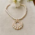 Elegant French style pearl necklace with large circular openwork pendant on linen - Necklace (HN13479) / White
