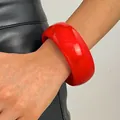 Detailed view of a wide red marbled resin bangle bracelet with a glossy finish. - Round (A-410) / 30mm / Red
