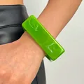 Detailed close-up showing the marbled pattern on a green wide resin bangle for women - Square (3245) / Green