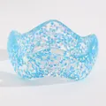 Detail shot of a wide blue resin bangle with iridescent geometric glitter and wavy edges. - Triangular Sequin Wave (5913) / Blue