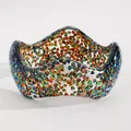 Close-up of a wide resin bangle with colorful iridescent triangular glitter pieces inside. - Triangular Sequin Wave (5982) / Green