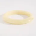 Close-up of a vintage wide resin bangle in creamy yellow with marbled texture - Miscellaneous Style (K-122) / Off White