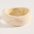 Close-up view of the vintage marble pattern on this wide resin bangle bracelet detail - Twisted (M-638) / White