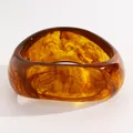 Detail shot of vintage amber swirled resin bangle showing marbled texture - Twisted (A-773) / Light Coffee