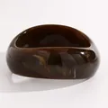 Macro detail view of retro marbled resin wide bangle showing amber texture and glossy finish - Twisted (G-607) / Dark Coffee
