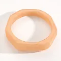 Close-up detail of a retro marbled peach resin wide bangle with smooth octagonal shape - UFO Shape (5680) / Beige