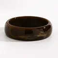 Close-up detail of a dark brown marbled resin wide bangle bracelet with a glossy finish - Small Round (7225) / 22mm / Dark Coffee
