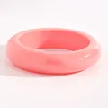 Close-up of smooth pink resin wide bangle bracelet for a retro minimalist look. - Arc Style (A-1120) / 21mm / Pink