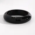 Close-up macro view of a vintage black marbled resin bangle with white swirled pattern - Arc Style (WG-1023) / 21mm / Black