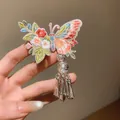 Detail view of butterfly embroidery hair clip with floral patterns and silver tassels. - Duckbill Clip (Pink-Green-1 Piece)