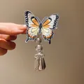 Detailed view of vintage butterfly embroidery hair clip with silver tassel and bell charm - Duckbill Clip (Black-Brown-1 Piece)