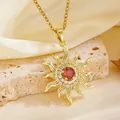Detailed macro shot of a gold sunburst pendant necklace featuring a central red stone - Gold Red Rhinestone Sun Style (T084)