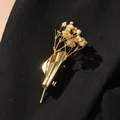 Elegant gold floral bouquet brooch pin featuring dried baby's breath flowers on blazer - Medium KC Gold (05 Med KC Gold 7736)