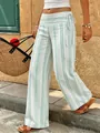 Women's striped wide-leg pants with low waist tie, shown in a relaxed outdoor vacation scene. - S / Bottoms / Light Green