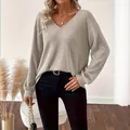 Close-up view of a stylish casual V-neck ribbed knit sweater in neutral light grey color - S / Tops / Khaki