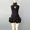 Detailed view of black bodycon dress with lace halter neck and rose flower hem - S / Dresses / Black