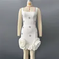 Close-up of white bandage dress with rhinestones and 3D rose ruffles at the hem. - S / Dresses / White