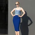 Close-up of a high-waisted blue bandage skirt on a model in bright sunlight - S / Bottoms / Blue