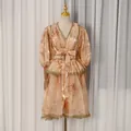 Detailed view of the French court style V-neck printed dress with elegant lace trim. - S / Dresses / Orange