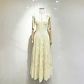 Close-up detail of a sweet yellow embroidered long dress with bow straps on a mannequin. - S / Dresses / Yellow