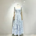 Detailed view of light blue spaghetti strap dress with white floral embroidery. - S / Dresses / Blue