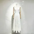 Detailed view of a white floral embroidered dress with sweetheart neckline and bow straps. - S / Dresses / White