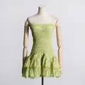 Detailed view of the light green eyelet embroidery and smocked bodice of a beach dress - L / Dresses / Green