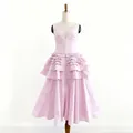 Elegant pink V-neck tiered ruffle midi dress with front button detailing displayed on mannequin - S / Dresses / Pink