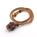 Macro shot of handmade woven mesh necklace featuring a natural purple amethyst stone pendant - Natural / Purple Crystal