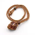 Detail of handmade woven rope necklace featuring a natural reddish gemstone pendant - Natural / Red Agate