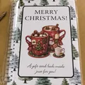 Spiral bound Christmas gift card book featuring festive mugs and gingerbread men illustration - 12-Page Pack / Christmas Cup Style