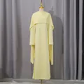 Detail view of a yellow high waist dress with elegant pearl-trimmed shawl on mannequin - S / Tops / Yellow