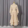 Elegant champagne French dress with lantern sleeves and pleated tiered skirt on mannequin - S / Dresses / Apricot