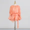 Close-up of elegant apricot pleated mini dress with balloon sleeves and waist tie - M / Dresses / Light Orange