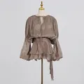 Close-up detail of elegant brown pleated mini dress with ruffles and a tie-waist design - S / Dresses / Chestnut