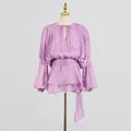 Close-up view of elegant purple pleated mini dress featuring a tie-neck and chic tiered hem - XL / Dresses / Purple