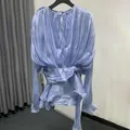 Elegant light blue pleated mini dress with tie-waist and round neck tie-back detail. - S / Dresses / Light Blue