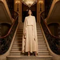 Elegant beige three-piece set featuring a long cape and maxi skirt in a grand interior - S / Set / Champagne