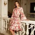 Full view of French style cherry print dress with tiered ruffles and elegant indoor background - S / Dresses / Red
