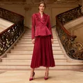 Detailed view of elegant magenta two-piece set with rhinestone blazer and pleated skirt - S / Top And Bottom / Burgundy
