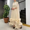 Detail of elegant cream maxi dress with ruffle hem and cape design for women - M / Dresses / Apricot