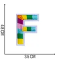 Detailed view of a colorful embroidered letter F patch with specific size dimensions - Letter F