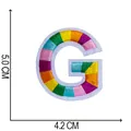 Detailed view of a rainbow embroidered letter G patch showing 5x4.2 cm dimensions. - Letter G