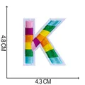 Close-up of rainbow embroidered letter K patch showing 4.8cm height and 4.3cm width dimensions - Letter K