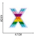 Detailed close-up showing the precise measurements of the colorful embroidered letter X patch - Letter X