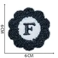 6cm Floral chenille embroidery patch featuring a black letter F on white and black felt - Letter F