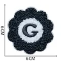 Flower shaped chenille embroidery patch featuring letter G in black and white, 6x6cm - Letter G