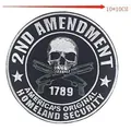Close-up of a circular black and white skull embroidery patch with gun motifs and 2nd Amendment text. - Skull Pattern (P18044)
