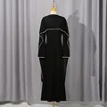 Detailed visual of a French black maxi dress with elegant shawl design and pearl bead trim - S / Tops / Black
